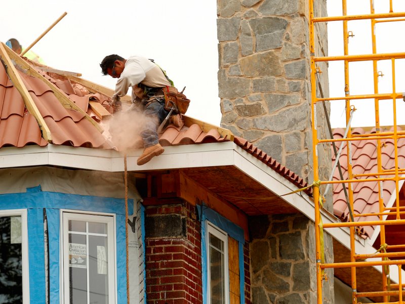 &copy; Reuters/Shannon Stapleton, A man works at the job site of a new home in Manhasset, New York.