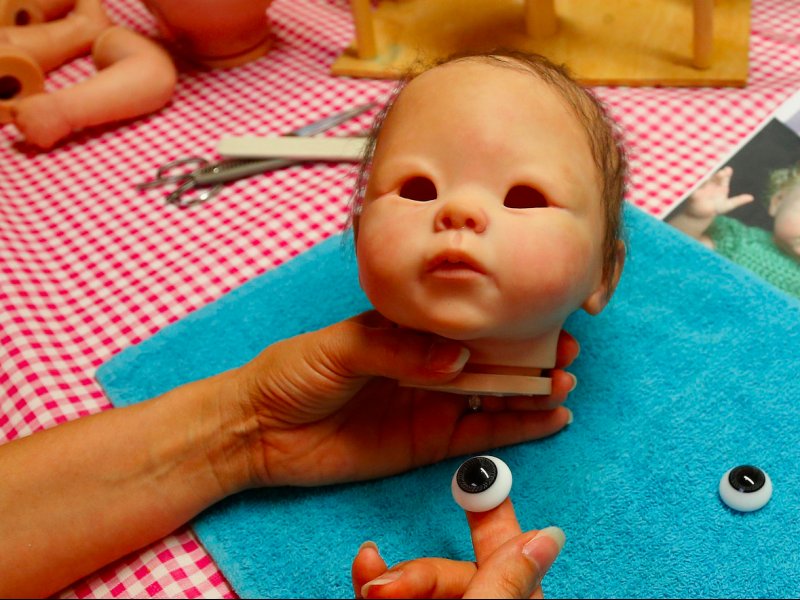 &copy; Reuters, Belgian artist Beatrice Van Landeghem prepares to insert eyes onto one of her life-like dolls, known as &quot;Reborn Babies&quot;, at her workshop called &quot;La nurserie des Tis Lous De Bea&quot; in La Louviere, southern Belgium August 8, 2013.