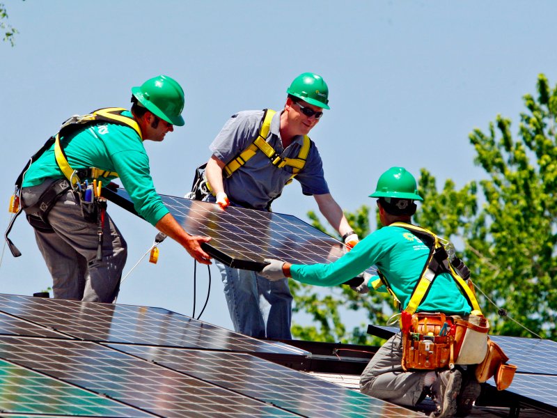 &copy; AP/Ed Andrieski, U.S. Senator Michael Bennet, D-Colo., center, helps as SolarCity employees Jarret Esposito, left, and Jake Torwatzky, install a solar panel on a home in south Denver.