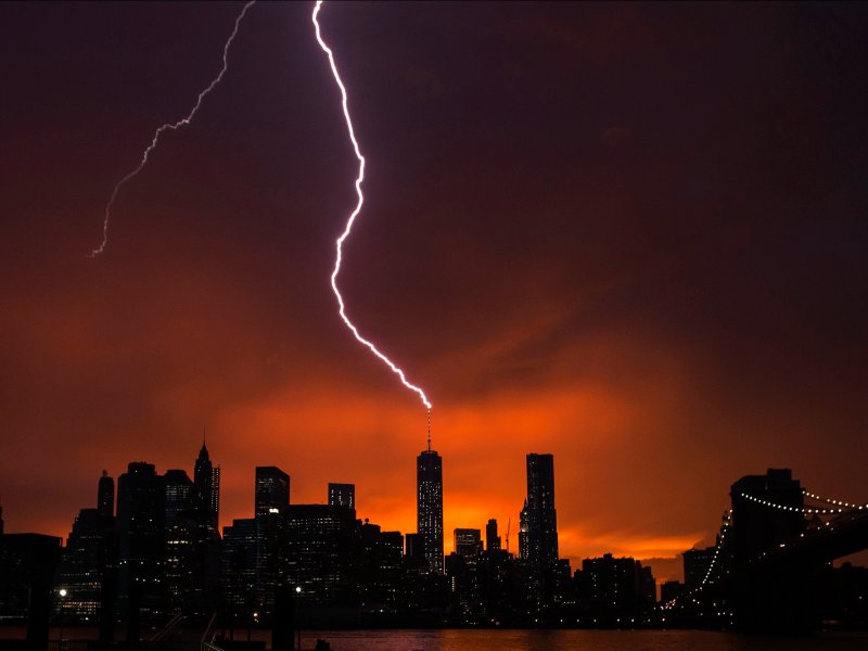 &copy; Reuters/Lucas Jackson, Lightning strikes One World Trade Center in Manhattan as the sun sets behind the city after a summer storm in New York.