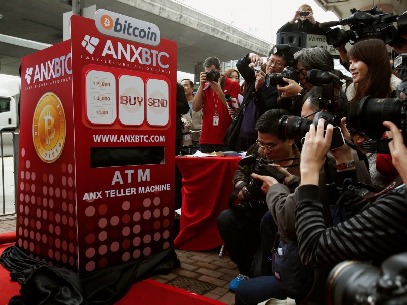 &copy; Reuters/Bobby Yip, Photographers in front of a mock bitcoin ATM in 2014 during the opening of Hong Kong&#039;s first bitcoin retail store.
