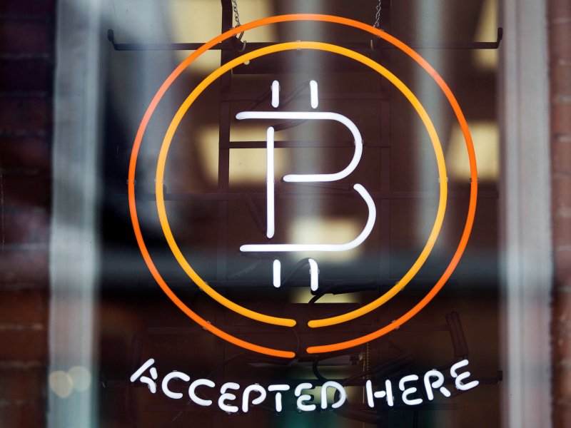 &copy; Reuters/Mark Blinch, A Bitcoin sign is seen in a window in Toronto.