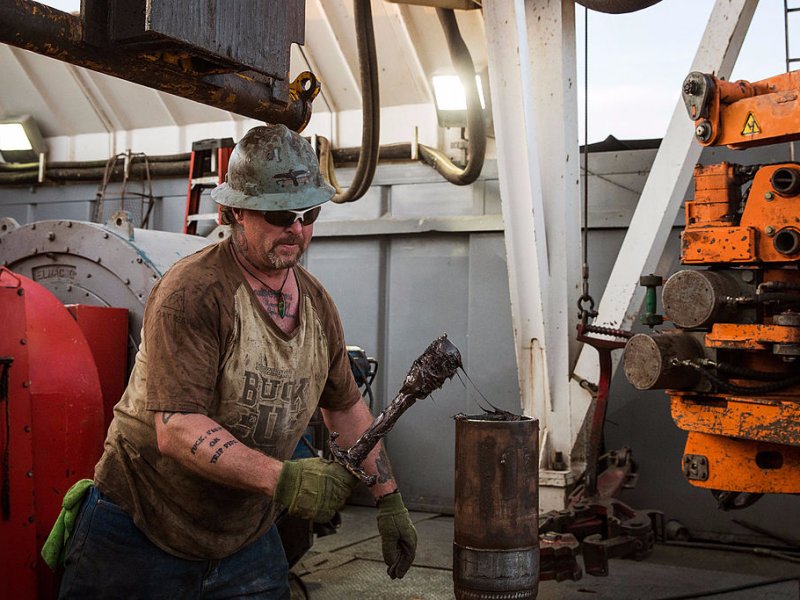 &copy; Andrew Burton/Getty, Glen Crabtree, a floor hand for Raven Drilling, lubricates a pipe while drilling for oil in the Bakken shale formation on July 23, 2013 outside Watford City, North Dakota