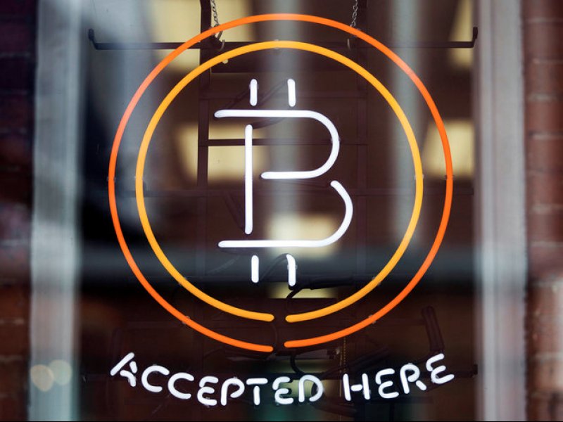 &copy; Thomson Reuters, A bitcoin sign in a window in Toronto.