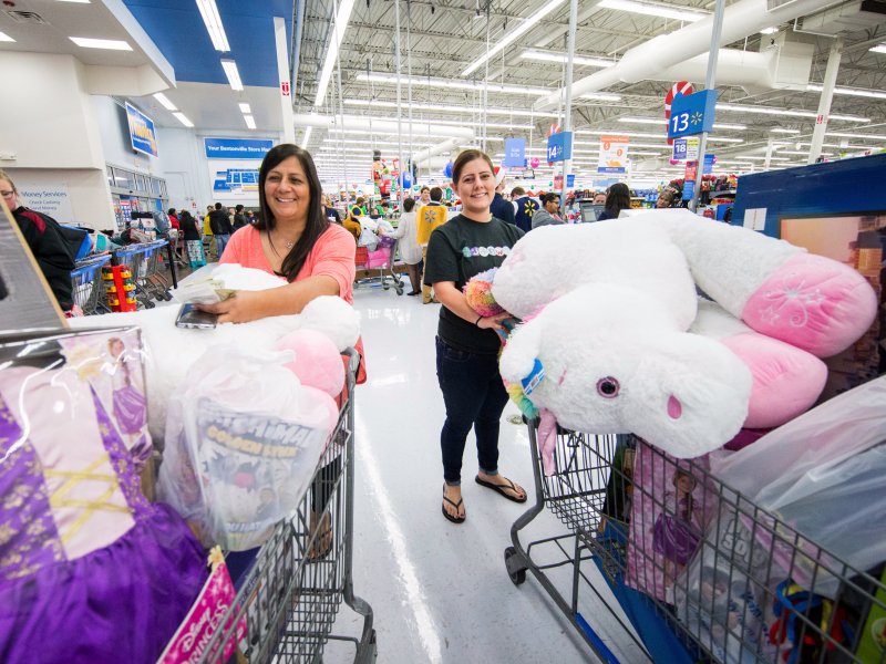 &copy; AP/Gunnar Rathbun, Walmart shoppers show off their Black Friday hauls.