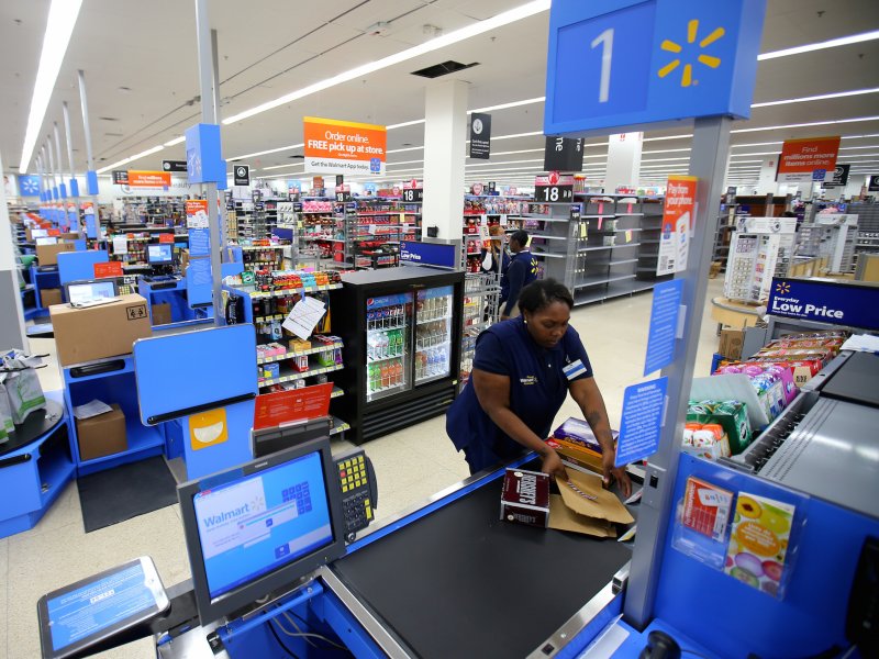 &copy; Reuters/Mike Blake, A worker prepares the check-out area at a newly built Walmart Super Center prior to its opening in Compton, California.