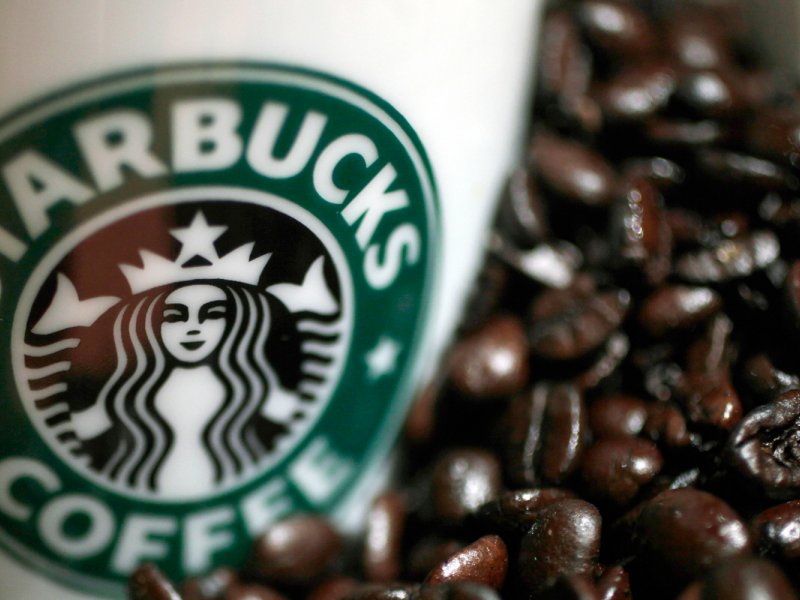 &copy; REUTERS/Yuriko Nakao, A mug bearing a Starbucks logo is pictured next to coffee beans during a news conference in Tokyo April 13, 2010.