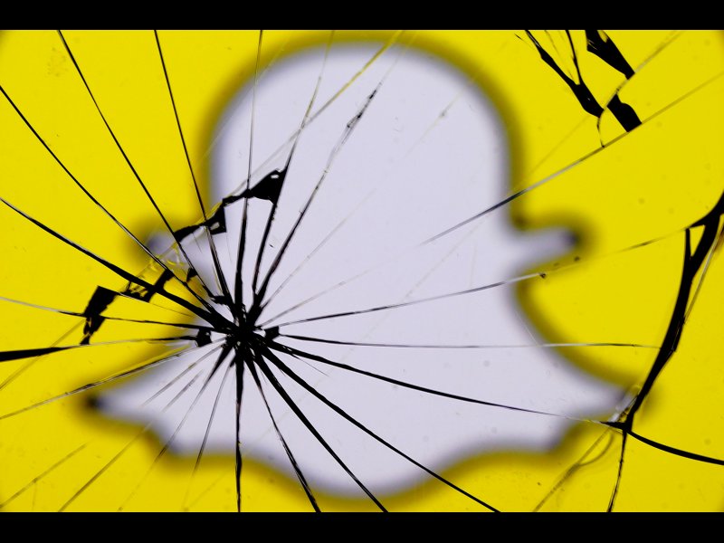 &copy; REUTERS/Dado Ruvic/Illustration, A Snapchat logo is seen through broken glass in this illustration picture, May 11, 2