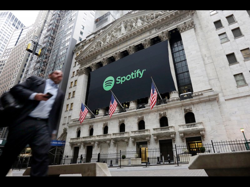 &copy; AP Photo/Richard Drew, A Spotify banner adorns the facade of the New York Stock Exchange, Tuesday, April 3, 2018. Spotify, the No. 1 music streaming service which has drawn comparisons to Netflix, is about to find out how it plays on the stock market in an unusual IPO.