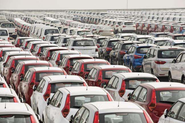 © Bloomberg. Vehicles stand at a port in Shanghai, China, on Monday, April 30, 2018. China won't succumb to 