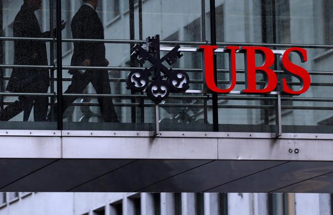 © Bloomberg. Employees pass between offices as UBS Group AG logo sits on a walkway at the UBS headquarters in Zurich, Switzerland, on Monday, Jan. 22, 2018. A UBS loan backed by shares of Steinhoff International Holdings NV was to blame for the majority of the Swiss banks 79 million francs ($82 million) in credit losses in the fourth quarter, a person with knowledge of the matter said.