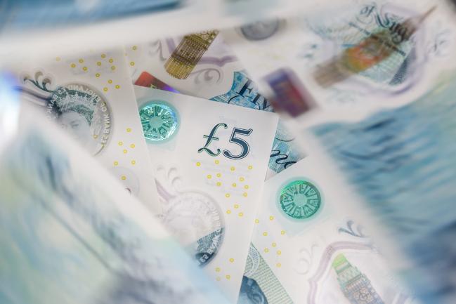 © Bloomberg. A collection of British five pound sterling banknotes sit in this arranged photograph in London, U.K., on Thursday, Oct. 13, 2016. The U.K. currency is getting harder to trade, and to predict, because the nations exit from the European Union has changed the rules of engagement.