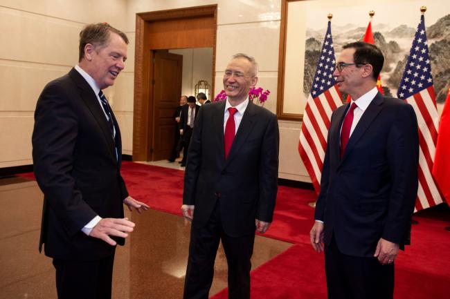 © Bloomberg. Robert Lighthizer, left, Liu He, and Steven Mnuchin on March 29. 