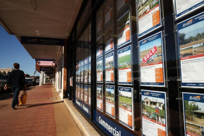 © Bloomberg. Properties listed for sale are displayed in the window of the Ruralco Property Davidson Cameron Real Estate agency in Narrabri, Australia, on Friday, May 26, 2017. A decade after the shale revolution transformed the U.S. energy landscape, Australia — poised to overtake Qatar as the world’s biggest exporter of liquefied natural gas — is experiencing its own quandary over natural gas. Photographer: Brendon Thorne/Bloomberg
