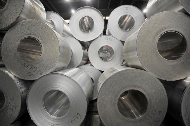 © Bloomberg. Rolls of sheet aluminum stand on pallets in a storage area ahead of shipping at the Impol Seval AD plant in Sevojno, Serbia, on Wednesday, Oct. 9, 2013. The London Metal Exchange\\'s plan to ease congestion at warehouses storing near-record amounts of aluminum will accelerate deliveries and reduce premiums paid for supply, at a time when prices are already near a four-year low.