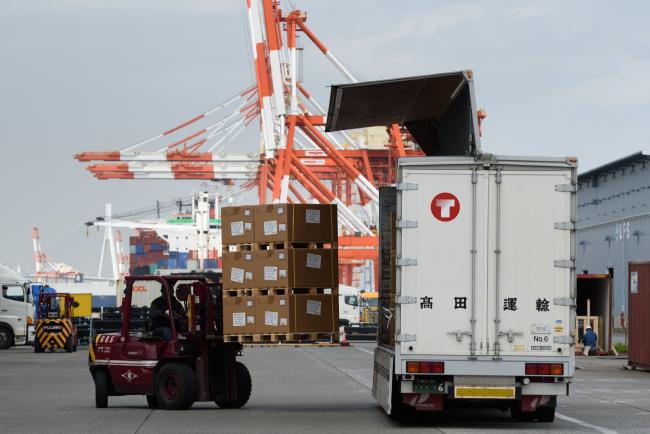 &copy Bloomberg. A worker operates a forklift to load boxes of goods onto a Takada Unyu KK truck at a shipping terminal in Yokohama, Japan, on Monday, April 16, 2018.  