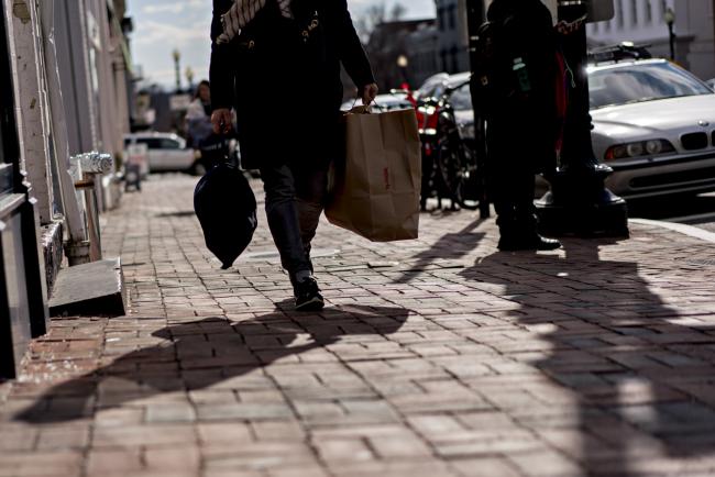 © Bloomberg. A pedestrian carries a TJX Cos. TJ Maxx shopping bag in the Georgetown neighborhood of Washington, D.C., U.S., on Wednesday, Jan. 24, 2018. Workers at men's apparel stores earned an average $23.13 an hour in November, a whopping 56 percent more than the $14.81 wage at women's retailers -- a gap that's widened from less than 10 percent about two years earlier, according to Labor Department data.