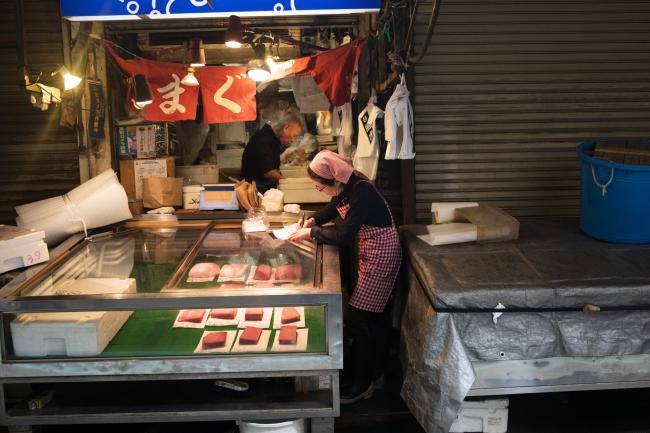 © Bloomberg. A vendor sorts paperwork at a store at the Tsukiji outer market in Tokyo, Japan, on Wednesday, April 17, 2019. The outer market shops and vendors sell everything from dried foods to kitchenware. Photographer: Keith Bedford/Bloomberg