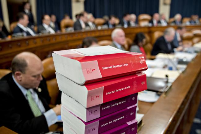 © Bloomberg. Internal Revenue Code books sit during a House Ways and Means Committee markup hearing in Washington, D.C., U.S., on Monday, Nov. 6, 2017. The House tax-writing committee began debate on the GOP's proposed overhaul, kicking off four frantic days for lobbyists and lawmakers to revise a bill that represents President Donald Trump's final hope for a signature legislative achievement this year.