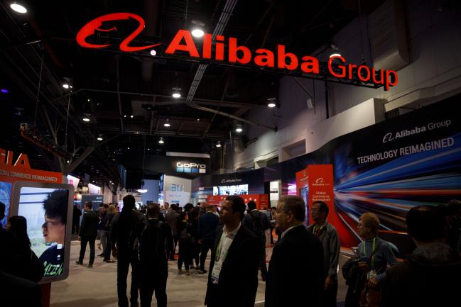 © Bloomberg. Attendees walk past the Alibaba Group Holding Ltd. booth at the 2019 Consumer Electronics Show (CES) in Las Vegas, Nevada, U.S., on Wednesday, Jan. 9, 2019. Dozens of companies will give presentations at the event, where attendance is expected to top 180,000, with the trade war between the U.S. and China as well as Apple's sales woes looming over the gathering. Photographer: Patrick T. Fallon/Bloomberg