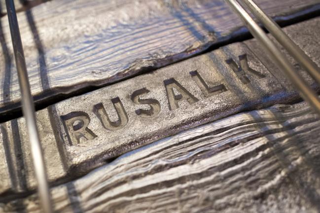 © Bloomberg. A Rusal logo stamp sits on an aluminum ingot awaiting shipment in a warehouse storage facility at the Krasnoyarsk aluminum smelter, operated by United Co. Rusal, in Krasnoyarsk, Russia, on Monday, Sept. 3, 2018. The season for aluminum producers and buyers to hash out U.S. sales contracts has started much earlier than usual this year thanks largely to uncertainties over sanctions on United Co. Rusal. 