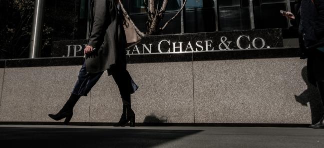 © Bloomberg. Pedestrians pass in front of a JPMorgan Chase & Co. office building in New York. 