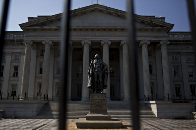© Bloomberg. A statue of Albert Gallatin, former U.S. Treasury secretary, stands outside the U.S. Treasury building in Washington, D.C., U.S., on Monday, July 16, 2018. The House this week plans to consider a minibus spending bill that combines legislation funding the Treasury, Internal Revenue Service (IRS), and the Securities and Exchange Commission (SEC) with another bill keeping the Interior Department and Environmental Protection Agency (EPA) running. Photographer: Andrew Harrer/Bloomberg