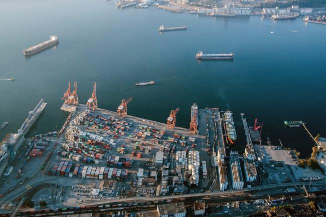 © Bloomberg. Containers sit stacked at Vancouver Harbour in this aerial photograph taken above Vancouver, British Columbia, Canada, on Thursday, Sept. 6, 2018. The U.S. and Canada continued to look for ways to bridge their differences as talks resumed to update the North American Free Trade Agreement, with Ottawa insisting it won't sign a bad deal. 