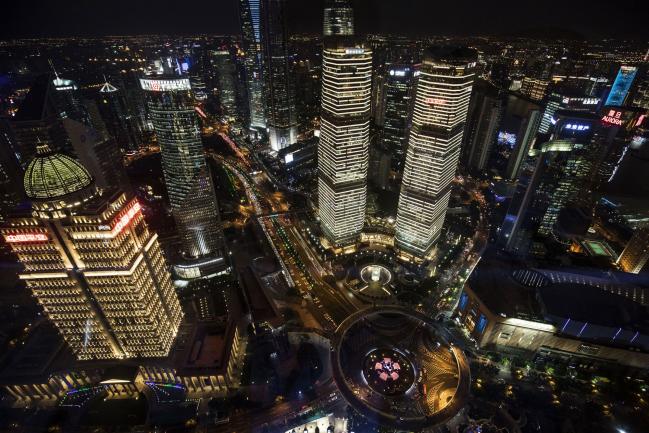 © Bloomberg. Illuminated commercial buildings are seen from the observation deck of the Oriental Pearl Tower at night in the Lujiazui Financial District in Shanghai, China, on Friday, Oct. 13, 2017. A number of economic indicators show \\