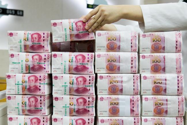 © Bloomberg. An employee arranges genuine bundles of Chinese one-hundred yuan banknotes at the Counterfeit Notes Response Center of KEB Hana Bank in Seoul, South Korea, on Monday, Aug. 14, 2017. China's factory output and investment slowed somewhat in July, according to data released today, yet the yuan appeared not to take the data as negative, if in fact it's paying attention to it at all. Photographer: SeongJoon Cho/Bloomberg