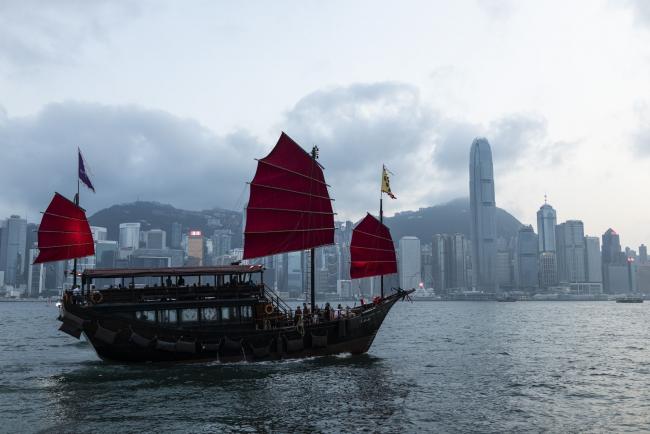 © Bloomberg. The Aqua Luna boat, operated by Aqua Restaurant Group, sails through Victoria Harbour as Two International Finance Center (IFC), center right, and other buildings on Hong Kong island stand in Hong Kong, China, on Monday, April 29, 2019. Hong Kong's gross domestic product will expand at a slower pace in the first quarter than the fourth because of the high base in the first three months of last year and due to external uncertainties, according to the city's financial secretary on April 28. 