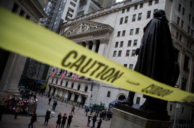 © Bloomberg. Caution tape hangs near the steps of Federal Hall across from the New York Stock Exchange (NYSE) in New York, U.S., on Monday, Nov. 20, 2017. The main U.S. equity gauge moved just a 10th of a percent last week, but investor hedging has jumped to a six-year high.