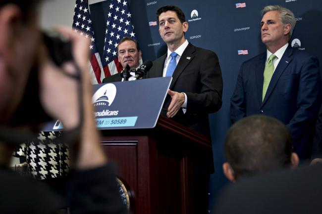 © Bloomberg. U.S. House Speaker Paul Ryan, a Republican from Wisconsin, center, speaks as House Majority Leader Kevin McCarthy, a Republican from California, right, listens during a news conference after a GOP conference meeting at the U.S. Capitol in Washington, D.C., on Dec. 19, 2017.