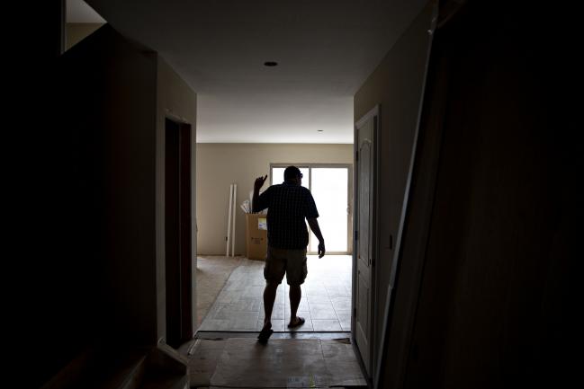 © Bloomberg. A prospective home buyer looks at the kitchen under construction at a house for sale in Dunlap, Illinois, U.S., on Sunday, Aug. 19, 2018. The National Association of Realtors is scheduled to release existing homes sales figures on August 22. Photographer: Daniel Acker/Bloomberg