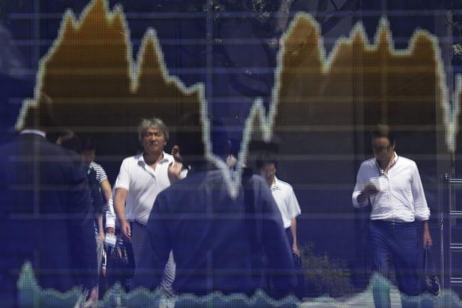 © Bloomberg. Pedestrians are reflected in an electronic stock board outside a securities firm in Tokyo, Japan, on Thursday, Aug. 30, 2018. Japan's Topix index closed lower after fluctuating as investors assessed trade frictions and geopolitical risks. 