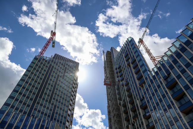 © Bloomberg. Construction cranes on the newly developed Upper Riverside residential development by London & Quadrant Housing Trust Ltd. (L&Q), on the Greenwich Peninsula in London, U.K., on Friday, April 26, 2019. The number of unsold homes under construction increased to 31,508 units as of March 31, the highest level recorded since Molior London began compiling the data a decade ago. 