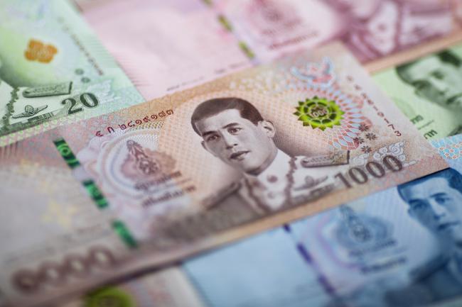 © Bloomberg. The portrait of Thai King Maha Vajiralongkorn is displayed on a 1,000 banknote baht in an arranged photograph in Bangkok, Thailand, on Wednesday, Sept. 12, 2018. The baht has been a stand-out currency amid the recent rout in emerging markets. It's appreciated 1.5 percent against the dollar so far this quarter, the best performer among major Asian currencies and the only gainer among them. Photographer: Brent Lewin/Bloomberg