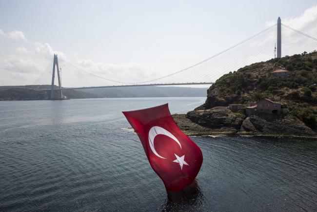 © Bloomberg. A Turkish national flag hangs above an inlet on the Bosporus strait near the newly opened Yavuz Sultan Selim bridge in Istanbul, Turkey, on Monday, Aug. 29, 2016. Turkish President Recep Tayyip Erdogan has demanded that lenders cut mortgage rates to an annual rate of about 9 percent from the market average of around 13.7 percent as he seeks to shore up the economy following the failed coup last month. Photographer: Kerem Uzel/Bloomberg