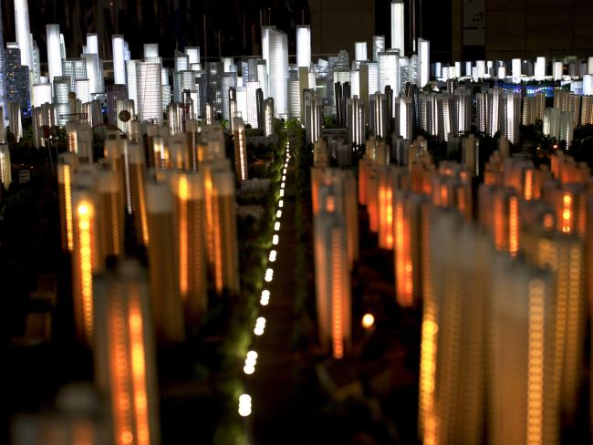 © Bloomberg. A scale model shows the skyline of the Manhattan-inspired Yujiapu financial district, background, in Tianjin, China, on Wednesday, Aug. 10, 2011. Photographer: Sim Chi Yin/Bloomberg