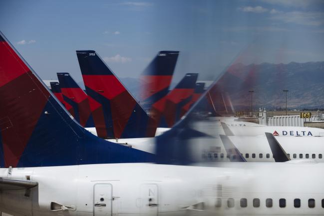 © Bloomberg. Delta Air Lines Inc. planes are seen reflected at Salt Lake City International airport (SLC) in Salt Lake City, Utah, U.S., on Thursday, July 5, 2018. 