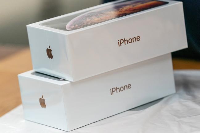 © Bloomberg. Boxes of the Apple Inc. iPhone XS sit at an Apple store during its launch in Hong Kong, China, on Friday, Sept. 21, 2018. The iPhone XS is up to $200 more expensive than last year's already pricey iPhone X and represents one of the smallest advances in the product line's history. But that means little to the Apple faithful or those seeking to upgrade their older iPhone. Photographer: Anthony Kwan/Bloomberg