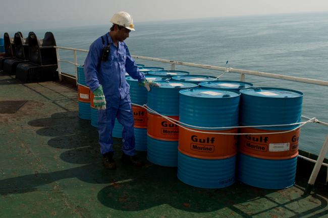 © Bloomberg. A crew man secures Gulf Marine oil drums on the deck of oil tanker 'Devon' as it prepares to transport crude oil from Kharq Island to India in Bandar Abbas, Iran, on Friday, March 23, 2018. Geopolitical risk is creeping back into the crude oil market. Photographer: Ali Mohammadi/Bloomberg