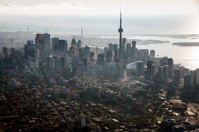 © Bloomberg. The CN Tower stands among buildings in the downtown skyline in this aerial photograph taken above Toronto, Ontario, Canada, on Monday, Oct. 2, 2017. Photographer: James MacDonald/Bloomberg