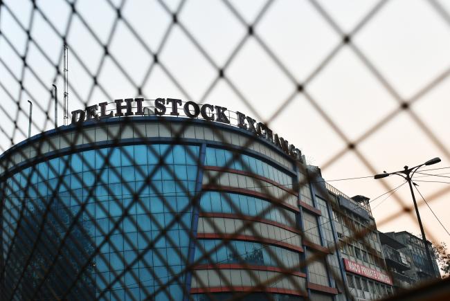 © Bloomberg. The Delhi Stock Exchange Ltd. building is seen through a fence in New Delhi, India, on Thursday, Nov. 10, 2016. Stocks in Asia rebounded from their steepest slide since Brexit, industrial metals surged and regional bonds tumbled after Donald Trump's election victory and spending pledges spurred gains in U.S. shares. 