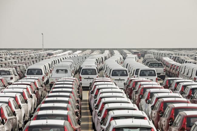 © Bloomberg. Vehicles stand at a port in Shanghai, China. Photographer: Qilai Shen/Bloomberg