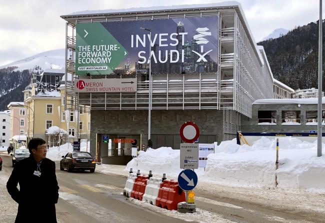 © Bloomberg. Ivest Saudi signage is displayed on the front of a building in the town of Davos, during the World Economic Forum, on Jan. 21, 2019. Photographer: Javier Blas/Bloomberg