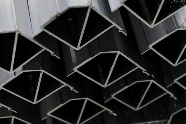 © Bloomberg. Aluminum parts are stacked at the Sapa SA aluminum plant in Bedwas, U.K., on Wednesday, Oct. 4, 2017. After being closed for three years due to a weak market, Sapa's aluminum plant in south Wales reopened to supply lightweight parts for automakers such as London Electric Vehicle Co., the maker of black cabs.