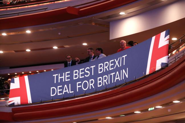 © Bloomberg. A Brexit banner sits in the stands ahead of the keynote speech by Theresa May, U.K. prime minister, during the Conservative Party annual conference in Birmingham, U.K., on Wednesday, Oct. 3, 2018. May is battling to assert her authority as U.K. prime minister after a disastrous start to her party's annual conference threatened to explode into a full-blown leadership crisis. Photographer: Chris Ratcliffe/Bloomberg