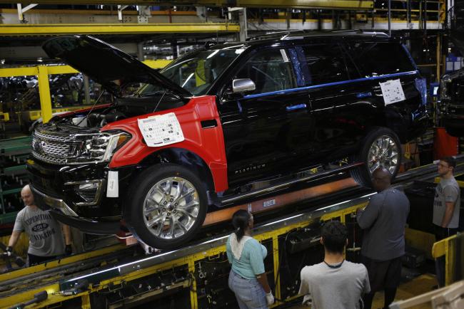© Bloomberg. Employees work on a Ford Expedition on the Kentucky plant assembly line in Louisville. Photographer: Luke Sharrett/Bloomberg