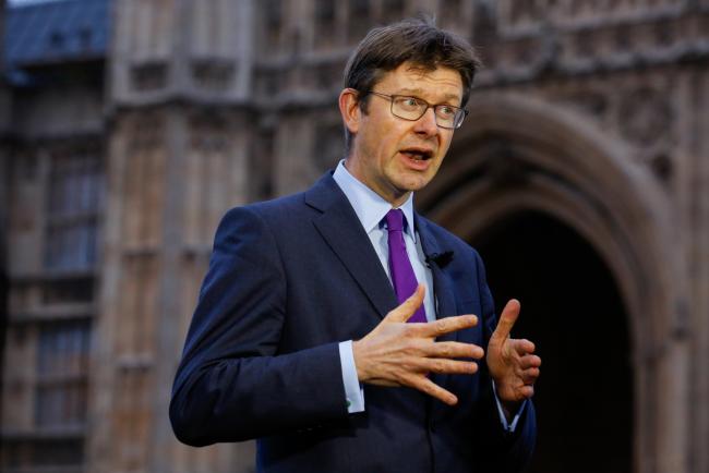 © Bloomberg. Greg Clark, U.K. business secretary, gestures while speaking during a Bloomberg Television interview in front of the Houses of Parliament in London, U.K. Photographer: Luke MacGregor/Bloomberg